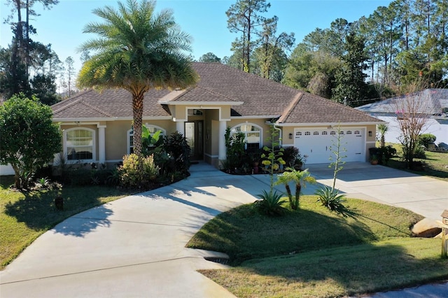 view of front of property featuring a front lawn and a garage