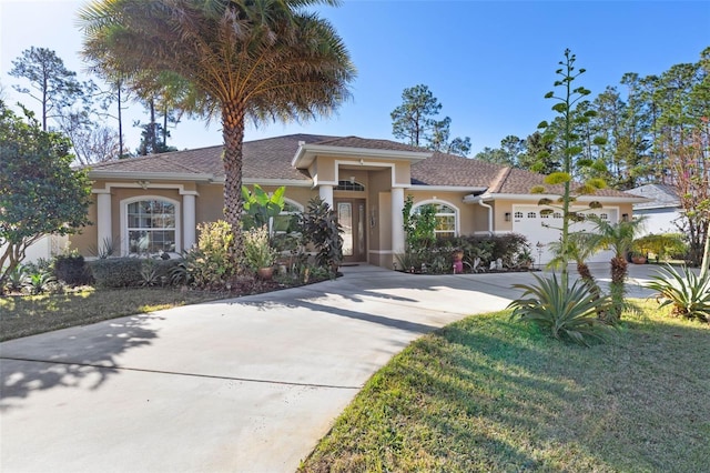 view of front facade featuring a front yard and a garage