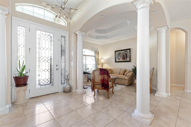 entryway featuring light tile patterned flooring, a chandelier, and ornamental molding