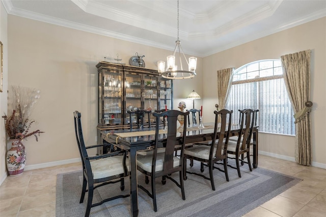 dining room with light tile patterned flooring, ornamental molding, and a raised ceiling