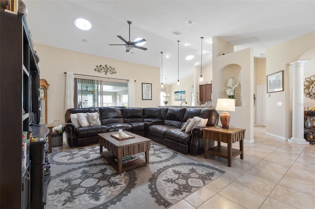 tiled living room featuring ceiling fan, high vaulted ceiling, and decorative columns