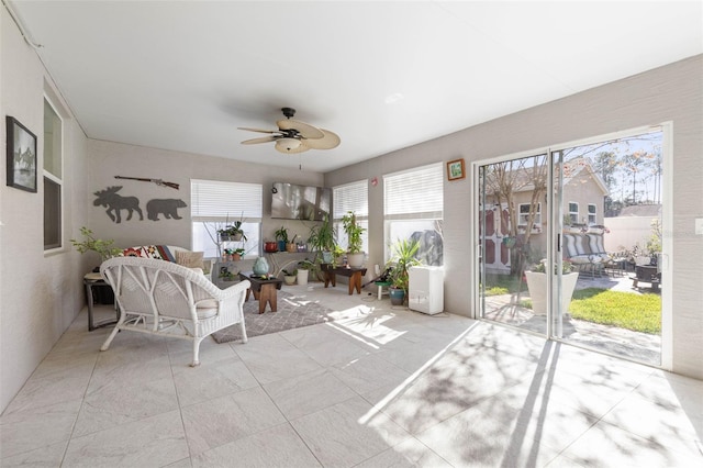 sunroom featuring ceiling fan