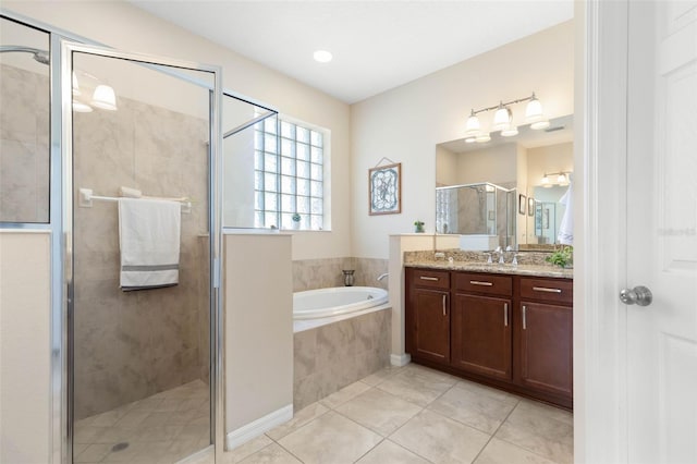 bathroom with vanity, tile patterned floors, and plus walk in shower