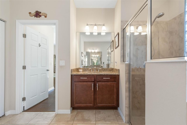 bathroom featuring walk in shower, vanity, and tile patterned flooring