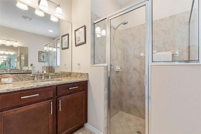 bathroom with an enclosed shower and vanity