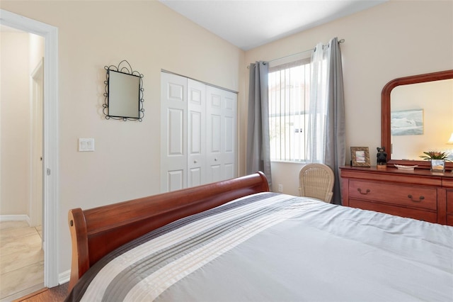 bedroom with light wood-type flooring and a closet