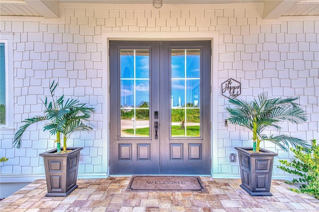 view of exterior entry featuring french doors