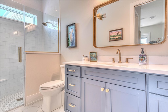 bathroom featuring an enclosed shower, vanity, tile patterned flooring, and toilet