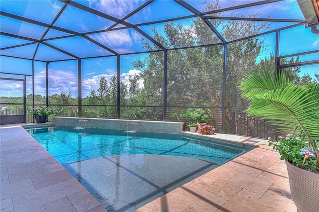 view of swimming pool with pool water feature, a patio area, and a lanai