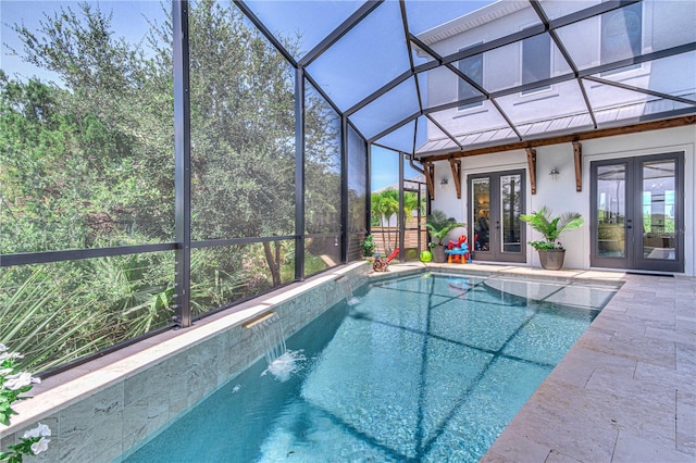 view of pool featuring glass enclosure, a patio area, pool water feature, and french doors