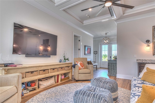 living room with hardwood / wood-style flooring, crown molding, coffered ceiling, and a notable chandelier