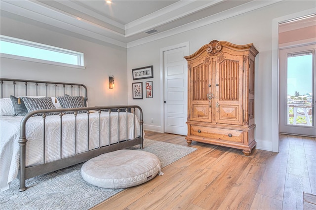 bedroom with crown molding, multiple windows, and hardwood / wood-style flooring