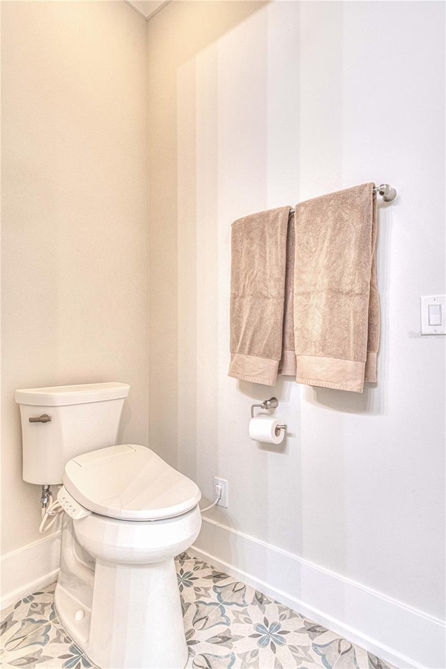 bathroom with toilet and tile patterned floors