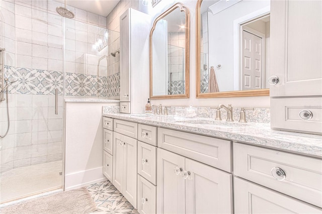 bathroom featuring tile patterned flooring, walk in shower, and vanity