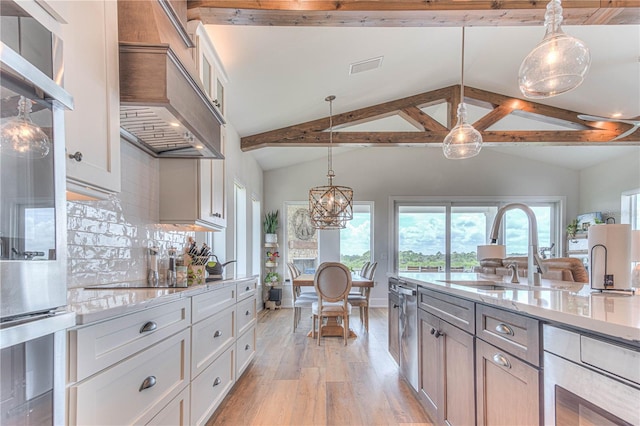 kitchen featuring decorative backsplash, pendant lighting, light hardwood / wood-style flooring, and lofted ceiling with beams