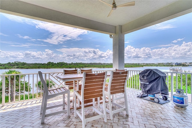 view of patio / terrace with ceiling fan, a water view, and a grill