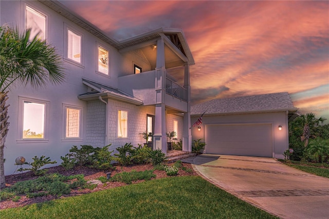 view of front of home with a balcony and a garage