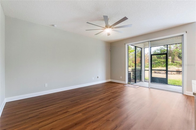 spare room featuring ceiling fan, a textured ceiling, and dark hardwood / wood-style flooring