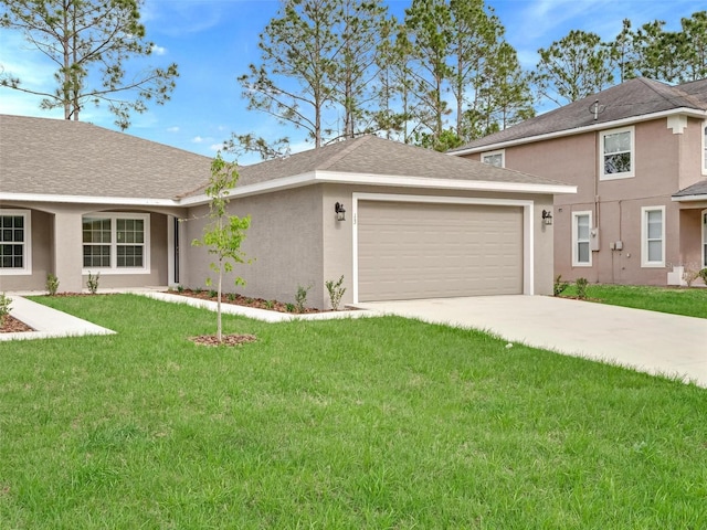 view of front of house featuring a garage and a front yard