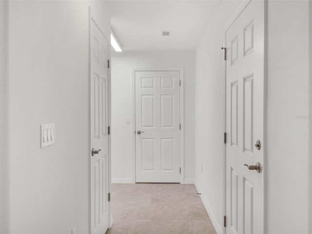 corridor with light tile patterned flooring