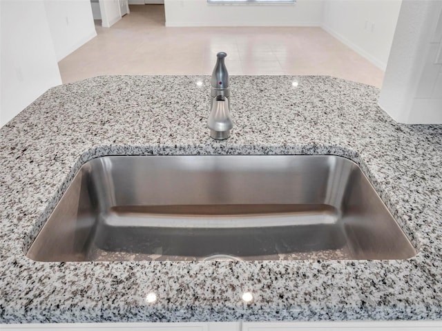 details with light stone countertops and sink