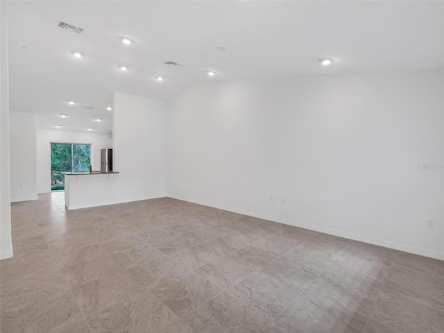 unfurnished room with lofted ceiling