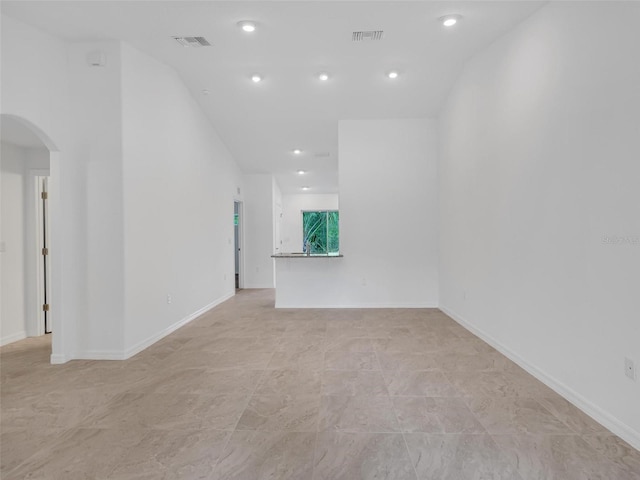 spare room featuring lofted ceiling