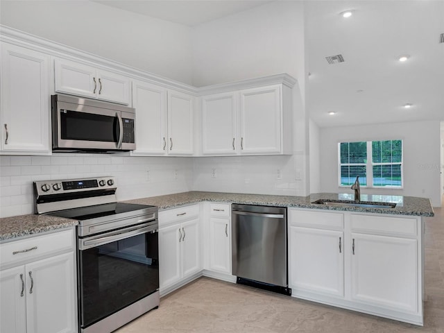 kitchen featuring stainless steel appliances, white cabinetry, and sink