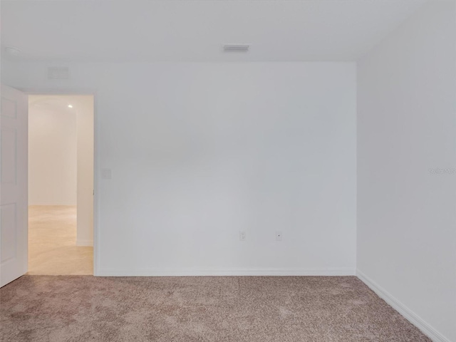 empty room with light colored carpet