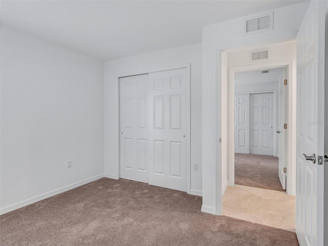 unfurnished bedroom with carpet floors and a closet