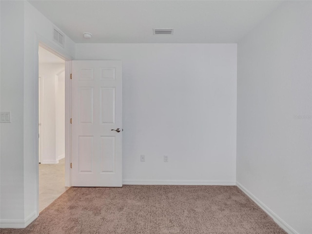 spare room with light carpet