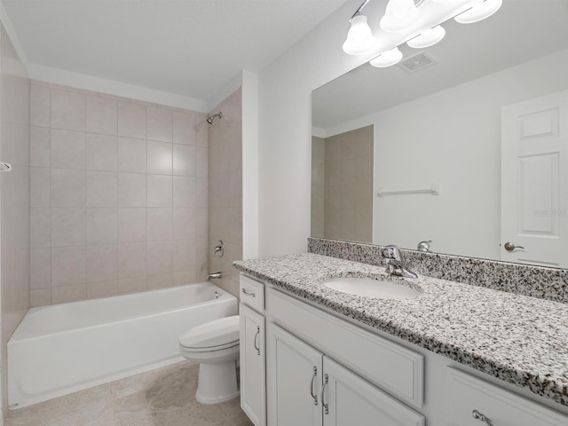 full bathroom featuring tile patterned floors, toilet, vanity, and tiled shower / bath