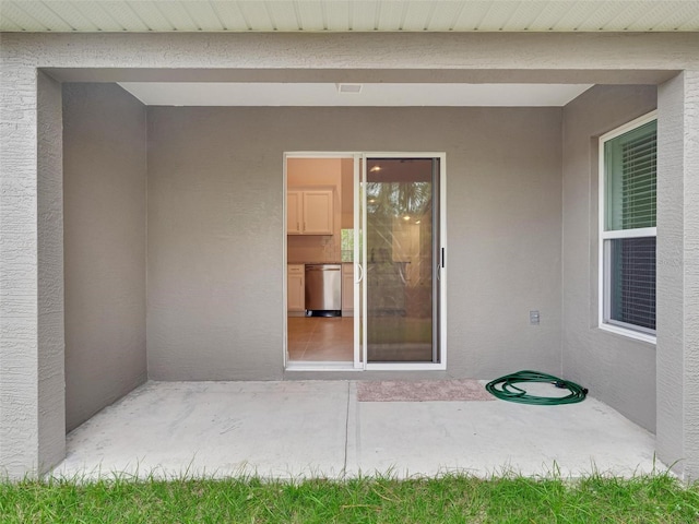 entrance to property with a patio