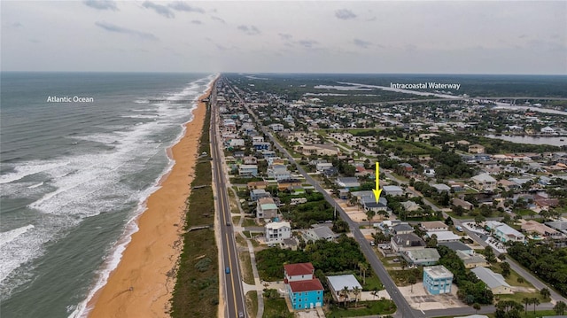 birds eye view of property with a view of the beach and a water view