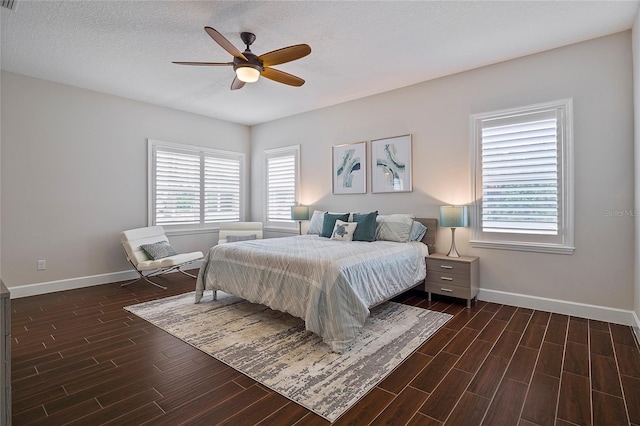 bedroom with ceiling fan and a textured ceiling