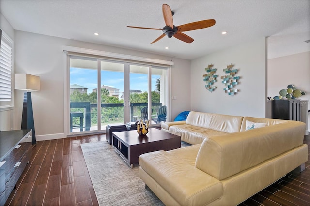 living room featuring ceiling fan, a healthy amount of sunlight, and a textured ceiling