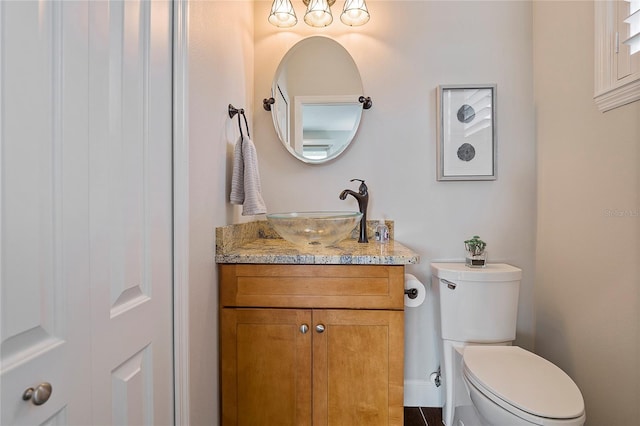 bathroom featuring toilet and vanity