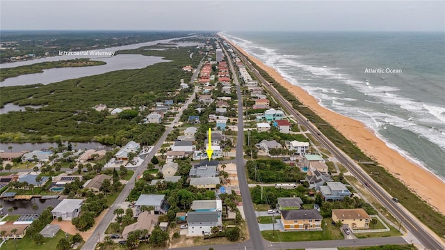 aerial view with a water view and a beach view