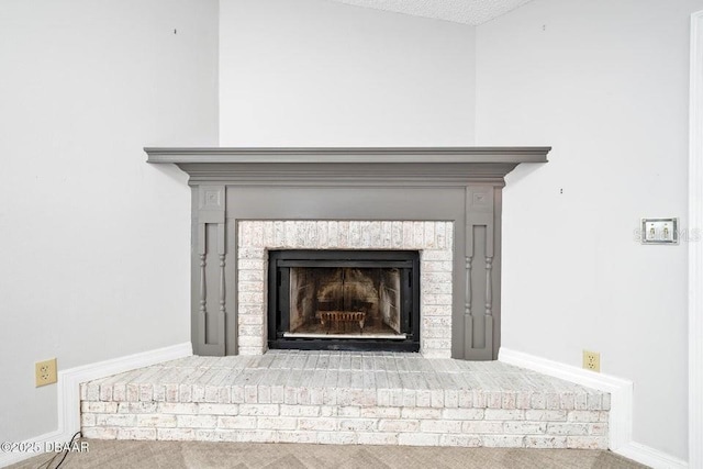 details with a brick fireplace and carpet