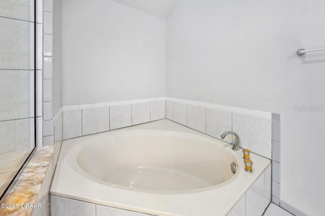 bathroom featuring tiled bath