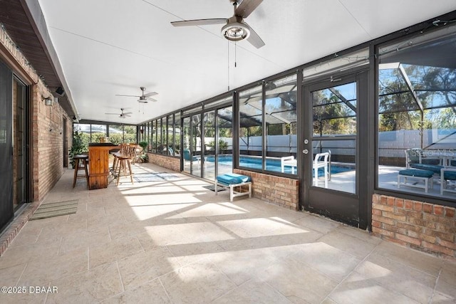 sunroom with ceiling fan