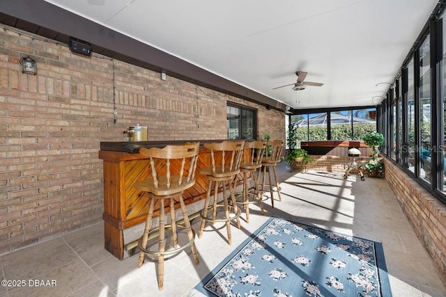 sunroom with bar and ceiling fan