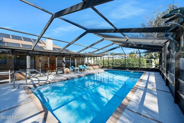 view of swimming pool featuring a lanai and a patio area