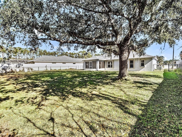 rear view of property featuring a yard