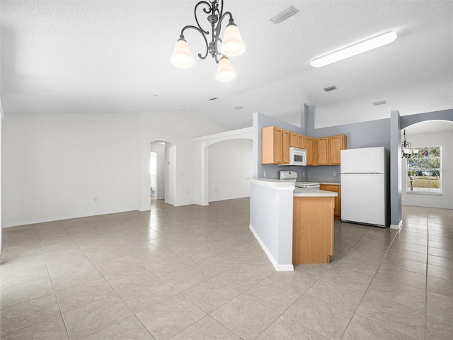 kitchen featuring a notable chandelier, light tile patterned floors, decorative light fixtures, and white appliances