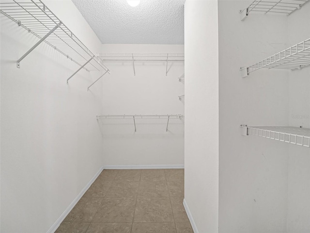 walk in closet featuring light tile patterned floors