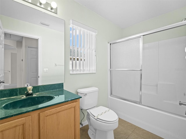 full bathroom with toilet, vanity, combined bath / shower with glass door, and tile patterned flooring