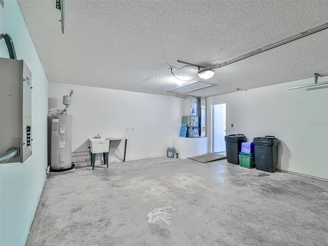 garage featuring electric water heater, sink, and a garage door opener