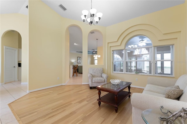 living room featuring light wood-type flooring and an inviting chandelier