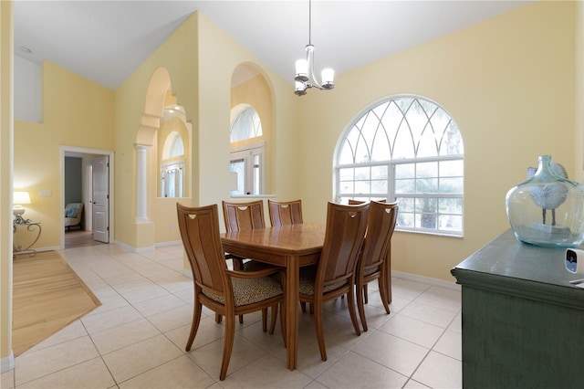 tiled dining room with a notable chandelier and decorative columns